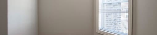 Bedroom two with rich wood flooring and neutral paint color