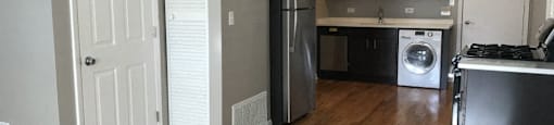 Open kitchen with rich flooring and stainless steel appliances