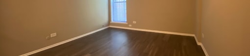 Large bedroom with a window and a ceiling fan