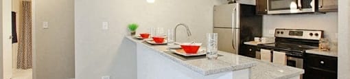 Kitchen with stainless steel appliances and a breakfast bar