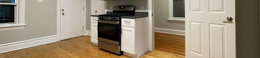 White cabinets and a built-in microwave