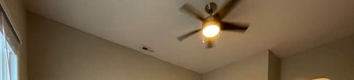 Living room with hardwood flooring and a ceiling fan