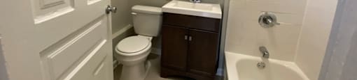 Bathroom with vanity storage and a full tub