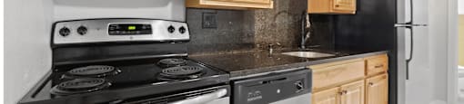 A kitchen with a stove, oven, microwave, and refrigerator at 23–33 Pearl St in Denver, CO
