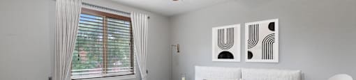 A bedroom with a bed, nightstand, and chair at 23–33 Pearl St in Denver, CO