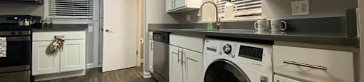 Kitchen with washer/dryer combo and stainless steel appliances