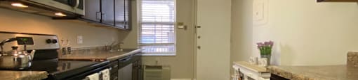 Kitchen with rich wood cabinetry - 2 Bedroom A
