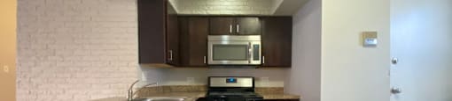 Kitchen with stainless steel appliances and a built-in microwave - 2 Bedroom B