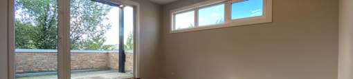 Main bedroom with hardwood floors and private balcony