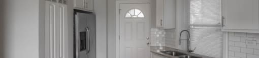 Open kitchen with brushed nickel pendant lighting