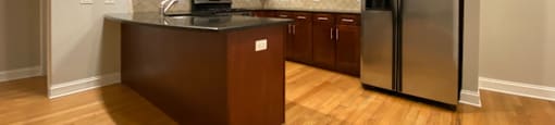 Kitchen with stainless steel appliances and tiled backsplash - 3 Bedroom