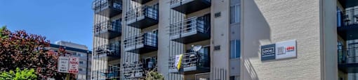 A modern apartment building with balconies and a gated entrance  at 4805 E Kentucky in Denver, CO