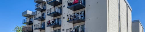 A modern apartment building with cars parked in front  at 4805 E Kentucky in Denver, CO