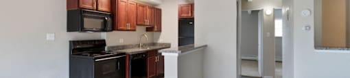 Spacious kitchen space featuring hardwood floors and all-black appliances