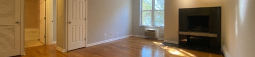 Spacious living area with hardwood flooring - Large One Bedroom