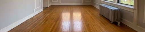 Hardwood flooring and large windows in the living area