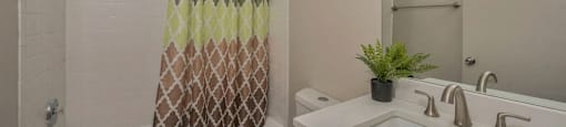 Bathroom with vanity storage and a full tub at Carriage House Lofts, Chicago