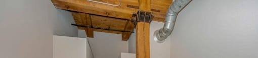 Bedroom with wood beams and high ceilings at Carriage House Lofts, Illinois, 60605