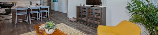 Open concept layout with gorgeous updated flooring and vaulted ceilings at Carriage House Lofts, Chicago, IL