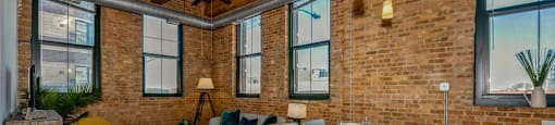 Open living area with a ceiling fan and lovely city views at Carriage House Lofts, Chicago