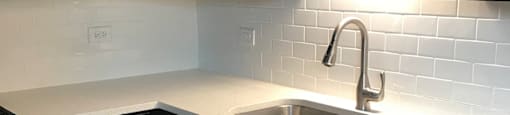 Kitchen with rich wood cabinetry and subway tiled backsplash