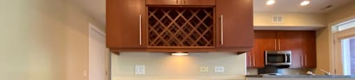 Gorgeous built-in desk with a wine cooler and wine rack