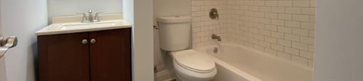 All-white bathroom with a tile backsplash