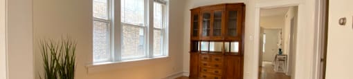 Large windows, built-in wooden cabinetry, and genuine hardwood floors