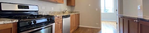 Hardwood floors, wooden cabinets, and stainless steel appliances