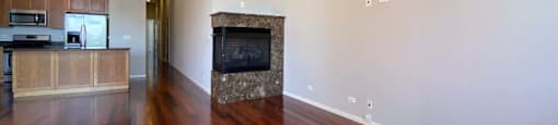 Spacious living area with hardwood floors and a built-in fireplace