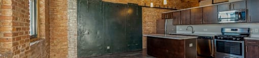 Spacious living area with a huge kitchen island at Carriage House Lofts, Illinois
