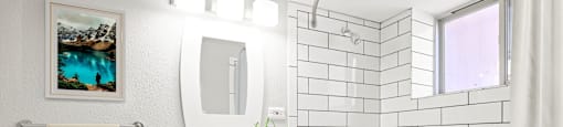 Bright, refreshed, and move-in ready. This spa-inspired bathroom features sleek subway tile, modern lighting, and a deep soaking tub at 1355 Pearl in Denver, CO