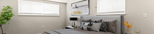 Spacious bedroom with natural light from dual windows, cozy modern design, and soft finishes that make it easy to unwind at 1444 Saint Paul St in Denver, CO
