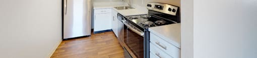 Upgraded stainless steel appliances, quartz countertops, and new cabinets at 878 S Dexter St in Denver, CO