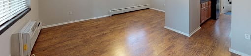Spacious living area with hardwood floors