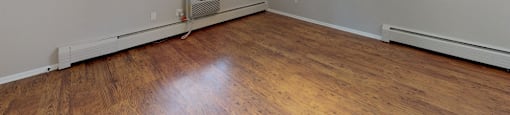 Bright living space with track lighting and hardwood floors