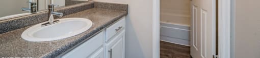 Bathroom with vanity storage and a full tub