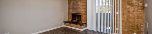 Living room with a fireplace and balcony access