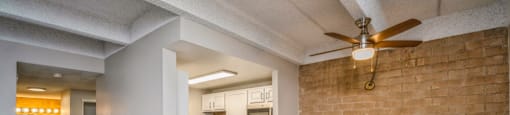 Open living area with a ceiling fan
