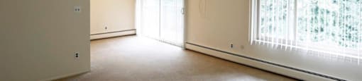 an empty living room with a large window