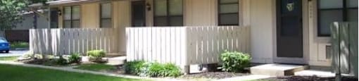 A small building with a fence in front of it.