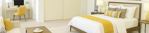 A bedroom with a bed, desk, and chair.