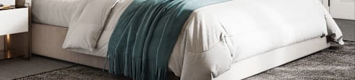 A bed with a white comforter and a blue blanket is in the center of the image.