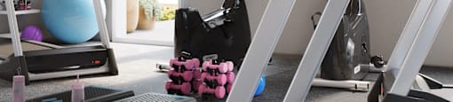 A gym with a treadmill, exercise ball, and weights.