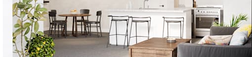 A modern kitchen with a dining table and chairs.