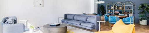 a living room with blue and yellow furniture and a blue ceiling
