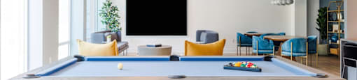 a pool table in a living room with a tv