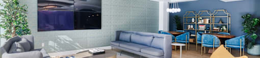 a living room with blue walls and yellow couches and chairs