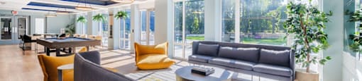 a living room with couches and chairs and a table