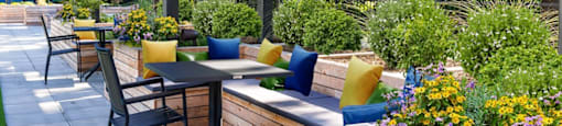 a patio with tables and chairs and a pergola